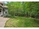 Expansive backyard with lush lawn and mature trees, offering privacy and room for outdoor activities at 8232 Glynmorgan Way, Chapel Hill, NC 27516