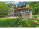 Spacious backyard with a patio and deck, perfect for outdoor entertaining or relaxing in a wooded setting at 8232 Glynmorgan Way, Chapel Hill, NC 27516