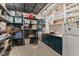 Finished basement storage area with ample shelving, countertop space, and a refrigerator for convenience and organization at 8232 Glynmorgan Way, Chapel Hill, NC 27516
