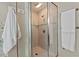 Modern bathroom features glass shower doors, neutral tiling, and decorative blue accent tiles at 8232 Glynmorgan Way, Chapel Hill, NC 27516