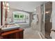 Bright bathroom with double sinks, a glass shower, and a soaking tub under a window, creating a spa-like atmosphere at 8232 Glynmorgan Way, Chapel Hill, NC 27516
