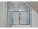 Elegant bathroom featuring a tub/shower combo with decorative tiling and a glass shower door at 8232 Glynmorgan Way, Chapel Hill, NC 27516