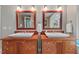 Bathroom featuring and wood vanities, with white basins and brushed silver hardware, creating a cozy atmosphere at 8232 Glynmorgan Way, Chapel Hill, NC 27516