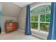 Bedroom featuring a large window with ample natural light and a view of a basketball hoop at 8232 Glynmorgan Way, Chapel Hill, NC 27516