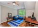 Office area features hardwood flooring, ample light, and a comfortable sofa with decorative cushions at 8232 Glynmorgan Way, Chapel Hill, NC 27516
