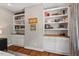 Bedroom with custom built-in shelving and storage, complemented by natural light from the large windows at 8232 Glynmorgan Way, Chapel Hill, NC 27516
