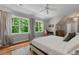 Bedroom features with hardwood floors, large windows, and a ceiling fan providing natural light at 8232 Glynmorgan Way, Chapel Hill, NC 27516