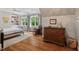 Bedroom with wood floors, a neutral color scheme, with built-in shelving and storage with natural light at 8232 Glynmorgan Way, Chapel Hill, NC 27516
