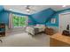 Bright bedroom with sloped ceilings, a ceiling fan, neutral carpeting, and ample natural light at 8232 Glynmorgan Way, Chapel Hill, NC 27516