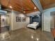 Bedroom area with concrete floors, murphy bed, and adjacent bathroom with white tile at 8232 Glynmorgan Way, Chapel Hill, NC 27516