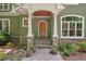 Charming entrance features a stone pathway, wood door, stone accents, and a covered porch at 8232 Glynmorgan Way, Chapel Hill, NC 27516