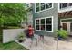 Exterior patio features a grill, seating and lush landscaping creating the perfect outdoor relaxation space at 8232 Glynmorgan Way, Chapel Hill, NC 27516