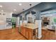 Spacious kitchen with a breakfast bar, wooden cabinets, stainless steel appliances, and hardwood floors at 8232 Glynmorgan Way, Chapel Hill, NC 27516
