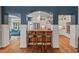 Modern kitchen boasts white cabinets, stainless steel appliances, and a breakfast bar for casual dining at 8232 Glynmorgan Way, Chapel Hill, NC 27516