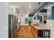 Bright kitchen featuring stainless steel appliances, white cabinets, and hardwood floors at 8232 Glynmorgan Way, Chapel Hill, NC 27516