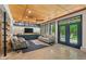 Spacious living room with wood ceiling, concrete floors, custom cabinets and large glass doors to the yard at 8232 Glynmorgan Way, Chapel Hill, NC 27516