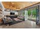Finished basement living room with a walkout patio, built-in cabinets, and a ceiling fan for added comfort at 8232 Glynmorgan Way, Chapel Hill, NC 27516