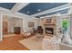 Inviting living room featuring hardwood floors, a stone fireplace, and ample natural light at 8232 Glynmorgan Way, Chapel Hill, NC 27516