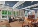 Bright living room featuring large windows, hardwood floors, and seamless access to the kitchen and outdoor views at 8232 Glynmorgan Way, Chapel Hill, NC 27516