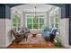 Bright living room featuring natural light, a beautiful chandelier, and ample seating for relaxation at 8232 Glynmorgan Way, Chapel Hill, NC 27516