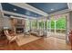 Inviting living room with a stone fireplace, hardwood floors, and access to the outdoor deck at 8232 Glynmorgan Way, Chapel Hill, NC 27516