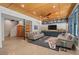 Spacious living room with wood ceiling, concrete floors, custom cabinets and a decorative area rug at 8232 Glynmorgan Way, Chapel Hill, NC 27516