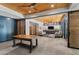 Open living area featuring concrete floors, custom cabinets, a wood ceiling, and a sliding barn door at 8232 Glynmorgan Way, Chapel Hill, NC 27516