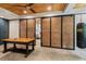 Open living area featuring concrete floors, custom cabinets, a wood ceiling, and a sliding barn door at 8232 Glynmorgan Way, Chapel Hill, NC 27516