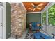 Cozy porch features a stone wall, comfortable seating, and a ceiling fan for added comfort at 8232 Glynmorgan Way, Chapel Hill, NC 27516