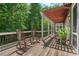 Inviting porch with rocking chairs, a pergola, and a serene view of the surrounding greenery at 8232 Glynmorgan Way, Chapel Hill, NC 27516