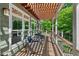 Relaxing porch with comfortable seating, a pergola, and views of the wooded landscape at 8232 Glynmorgan Way, Chapel Hill, NC 27516