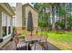 Inviting backyard with a wooden deck, outdoor dining set, and a lush green lawn, perfect for entertaining at 8613 Swarthmore Dr, Raleigh, NC 27615