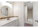Bathroom featuring a vanity with mosaic tile backsplash and white cabinets at 8613 Swarthmore Dr, Raleigh, NC 27615