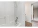 Bathroom tub with tile surround and showerhead, and white tile at 8613 Swarthmore Dr, Raleigh, NC 27615