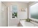 Bright bathroom with a separate shower, soaking tub, and modern fixtures at 8613 Swarthmore Dr, Raleigh, NC 27615