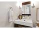 Modern bathroom featuring a sleek vanity with a stylish mirror, contemporary lighting, and neutral wall color at 8613 Swarthmore Dr, Raleigh, NC 27615