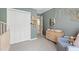 Bedroom showcasing a neutral color scheme, closet, and changing table at 8613 Swarthmore Dr, Raleigh, NC 27615