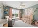 Bedroom features a plush chair, neutral carpet, ample sunlight, and coordinated decor at 8613 Swarthmore Dr, Raleigh, NC 27615
