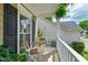 Cozy covered front porch with a table and chairs for relaxing at 8613 Swarthmore Dr, Raleigh, NC 27615