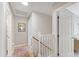 Upstairs hallway features hardwood floors, neutral walls, white trim, and access to multiple rooms at 8613 Swarthmore Dr, Raleigh, NC 27615