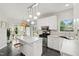 Bright kitchen with white cabinets, stainless steel appliances, and island at 8613 Swarthmore Dr, Raleigh, NC 27615