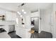 Well-lit kitchen boasts white cabinets, stainless steel appliances, island, and contrasting dark tile flooring at 8613 Swarthmore Dr, Raleigh, NC 27615