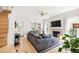 Bright living room featuring a fireplace, ceiling fan, and hardwood floors at 8613 Swarthmore Dr, Raleigh, NC 27615