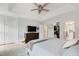 Spacious main bedroom with a plush bed, dark wood dresser, ceiling fan, and ample closet space at 8613 Swarthmore Dr, Raleigh, NC 27615