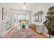 Bright playroom with hardwood floors, large windows, and ample natural light, perfect for activities at 8613 Swarthmore Dr, Raleigh, NC 27615