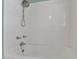 Bathroom shower/tub with white tiled walls, chrome fixtures, and shower head at 917 Saint Marys St, Raleigh, NC 27605