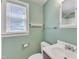 Bathroom with toilet, sink, medicine cabinet and window that provides natural light at 917 Saint Marys St, Raleigh, NC 27605
