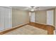 Bedroom with hardwood floors, ceiling fan, window with blinds, and large closet at 917 Saint Marys St, Raleigh, NC 27605