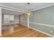 Open-concept space with hardwood flooring, light green walls, and stylish lighting at 917 Saint Marys St, Raleigh, NC 27605