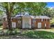 Charming brick multi-Gathering home with lush green lawn and mature trees providing ample shade at 917 Saint Marys St, Raleigh, NC 27605